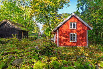 Red wooden cottage in Swedish countryside at autumn © Lars Johansson