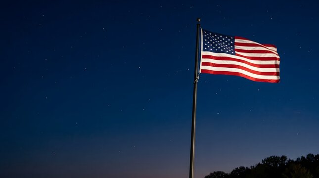 American flag waving at dusk on Veterans Day with a starry night sky