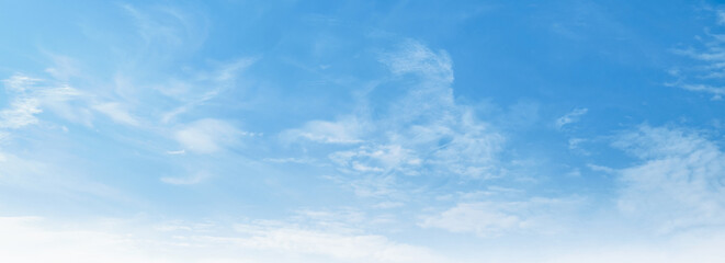 Clear blue sky with wispy clouds drifts gently © lovelyday12