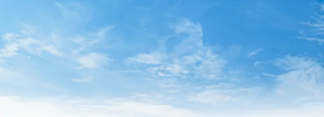 Clear blue sky with wispy clouds drifts gently © lovelyday12