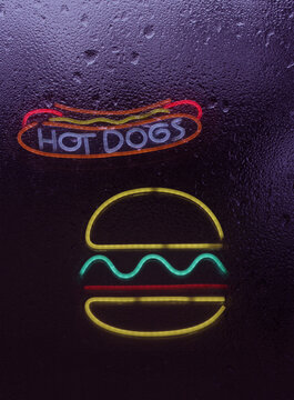 Vintage Neon Style Lights in Rainy Window of Cafe