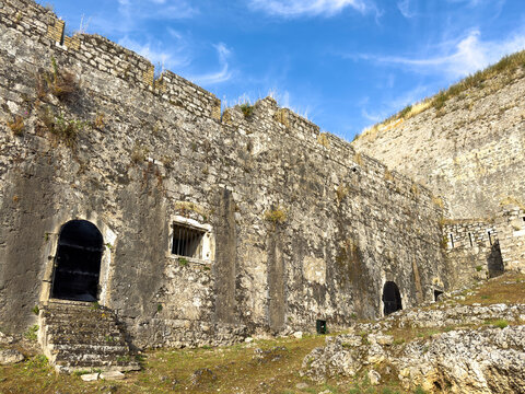 New Fortress stone ramparts and arched doorways in Corfu Town, Greece under blue sky