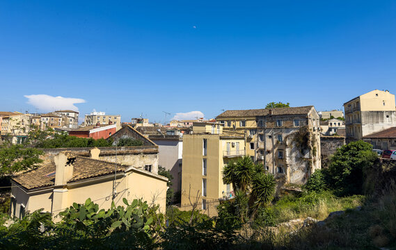 Corfu Town, Greece rooftops and stucco buildings view from New Fortress under blue sky