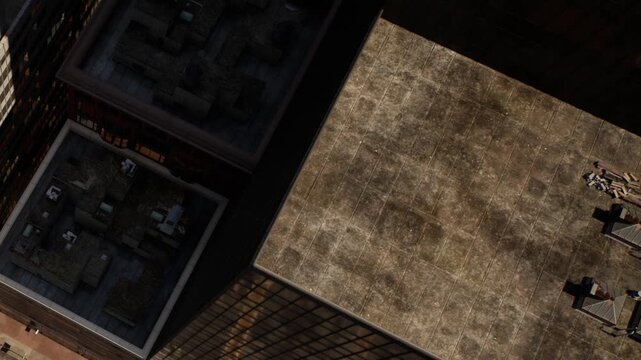 Rooftops of buildings in a city. The sun creates shadows on the surfaces. Some rooftop units are visible while others seem empty. The time appears to be midday.