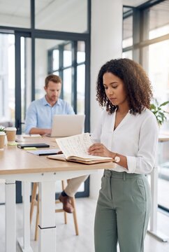 Woman reviewing paperwork in open office