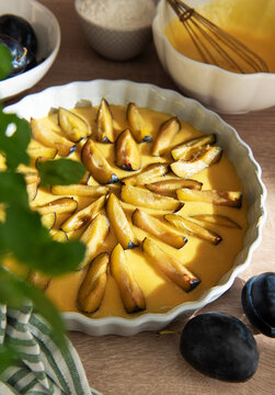 Preparing homemade plum tart for baking dessert