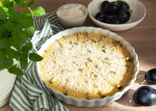 Baking plum crumble with fresh fruit and mint