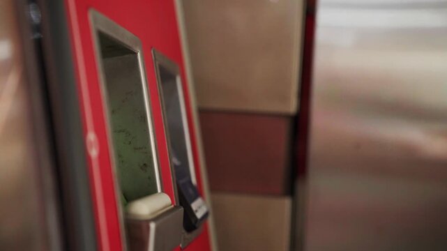 Person paying with smartphone on public transport ticket validator