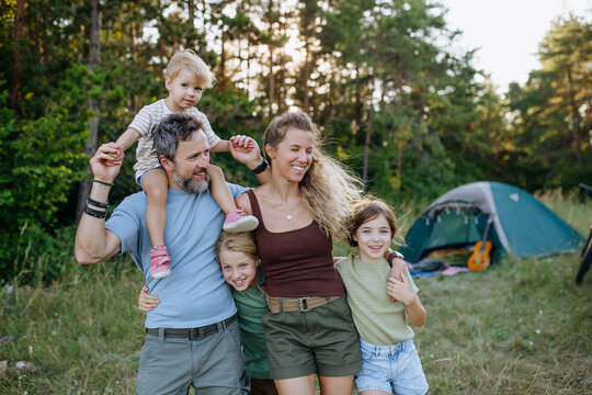 Happy family spending time together during summer camping trip.