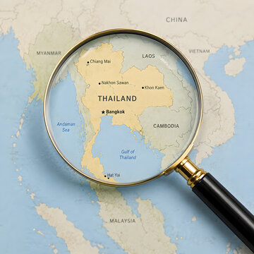 Close up view of magnifying glass over Thailand map for travel and exploration concept