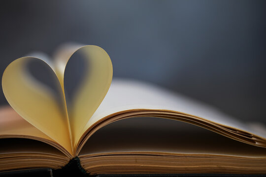 Heart-Shaped Page in Open Book Symbolizing Love for Reading and Literature Appreciation