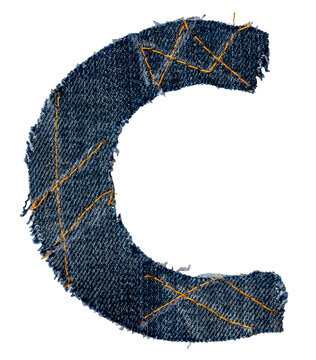 A letter of the alphabet cut out of a piece of denim fabric on a white background. Letters isolated