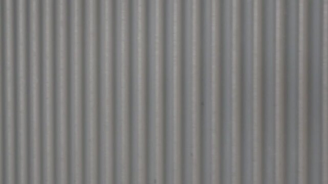 Close-up of the ribbed metal side panel of a train carriage, Cannes, France