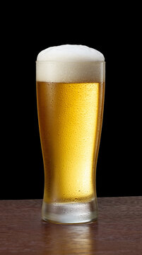 Glass of beer with frothy beer head