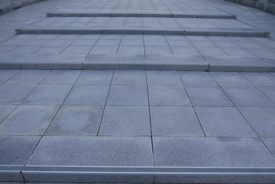 Perspective view of modern grey stone tiled outdoor stairs