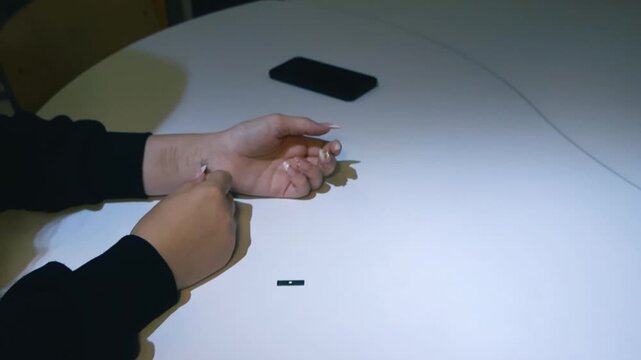Futuristic concept of a person self implanting a microchip transponder under the skin of their wrist for data access and personal identification using a special applicator tool