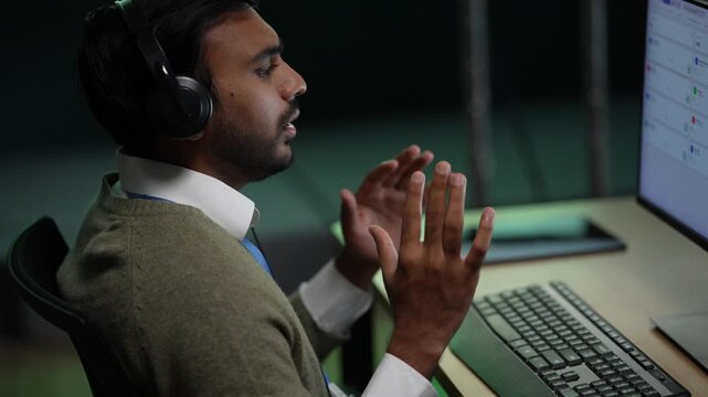An engineer behind a note covered glass wall holds a hand to his chin, then lifts a pen to mark the step that has been bothering him inside a dark AI startup office.