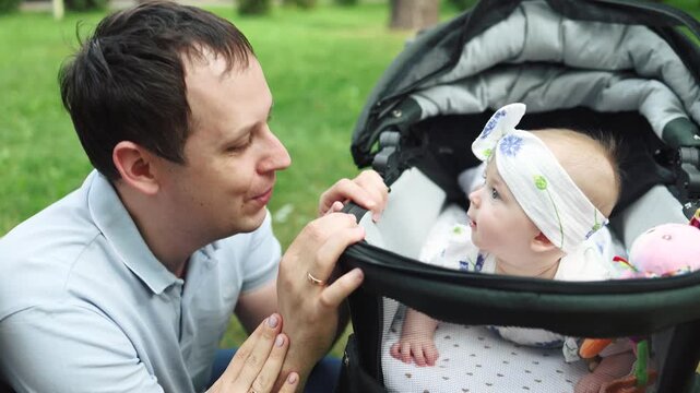 Mother and father gently push baby stroller. Baby rests peacefully in car seat. Pedestrian cross is visible nearby. Scene portrays calm, everyday parenting moment
