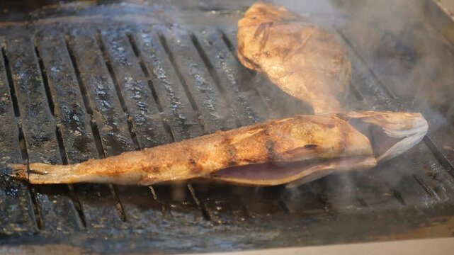 Grilling fish at a local market in the afternoon