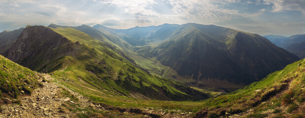 Beautiful deep mountain valley stretching between high green ridges © Jan