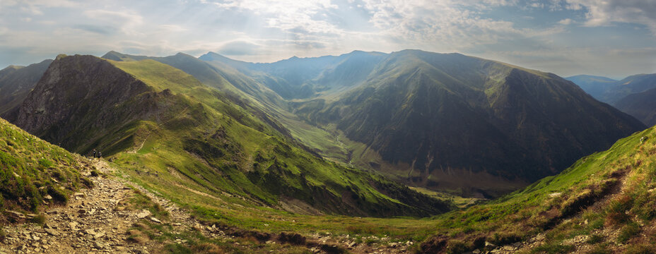 Beautiful deep mountain valley stretching between high green ridges