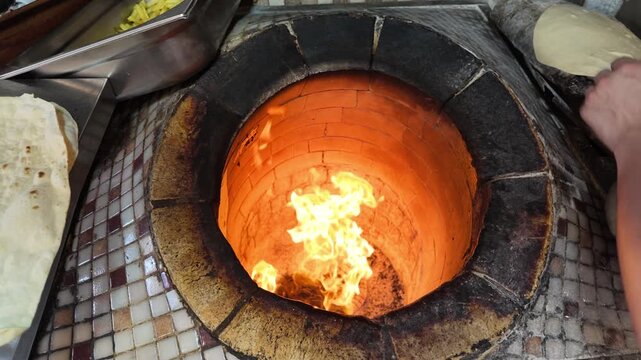 Baking bread in a traditional Indian oven