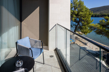 Obraz premium Hotel balcony view overlooking sea and green coastal trees