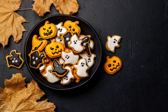 Halloween cookies on black stone background with copy space