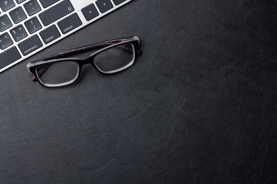 Office supplies on dark leather desk
