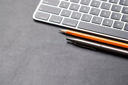 Office supplies on dark leather desk
