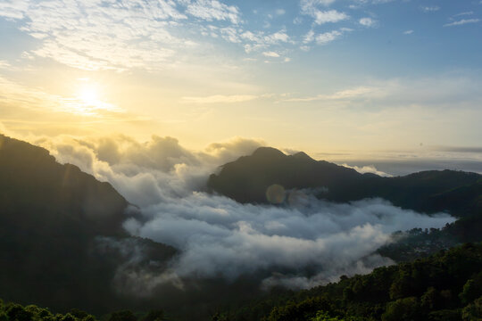 Sunrise mountain valley forest cloud mist northern thailand landscape over mountain valley and forest beneath sea of cloud, warm light creating tranquil nature view