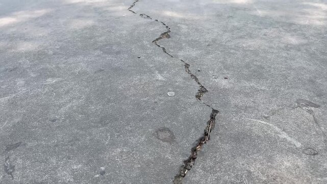 High angle view of cracked concrete surface