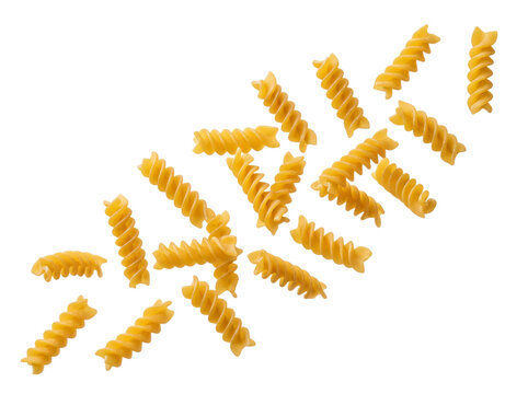 Yellow raw spiral fusilli pasta pieces floating in air with bright kitchen lighting to enhance texture on transparent background