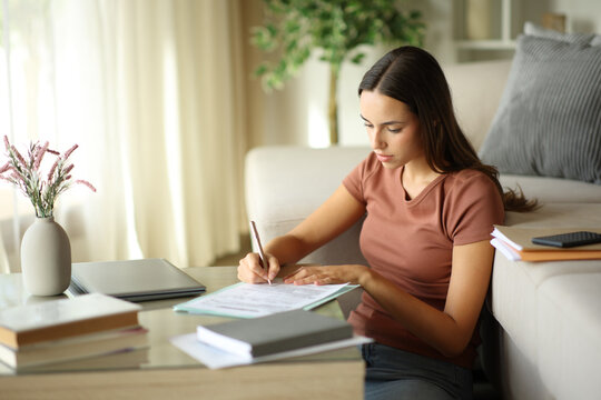 Telecommuter signing contract or filling form working at home