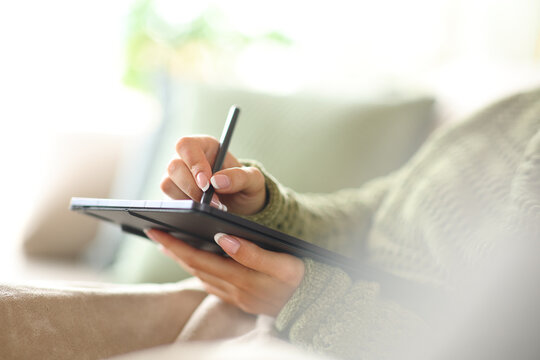 Woman hands handwriting or drawing on tablet at home