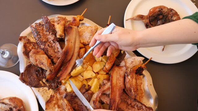 Meat kebabs and quail wings grilled on a plate. Festive dinner . High quality 4k footage