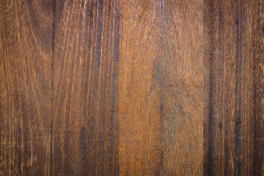 Dark brown teak wood texture background with natural grain pattern.