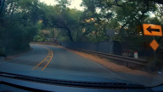 Dashcam Cold Canyon Rd car drives winding road through dense green trees California mountain pass residential area daytime driving POV journey adventure route