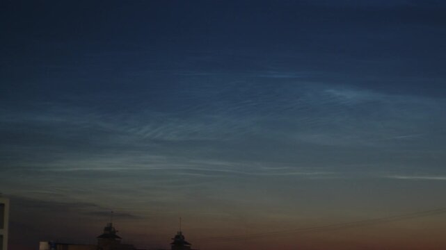 Noctilucent clouds or NLC in the summer sky on the northern hemisphere, on 56,5 degrees of latitude.