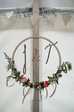 Wreath with initials and flowers as wedding decoration