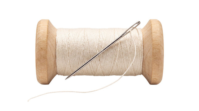 Wooden spool of white thread with needle over transparent background