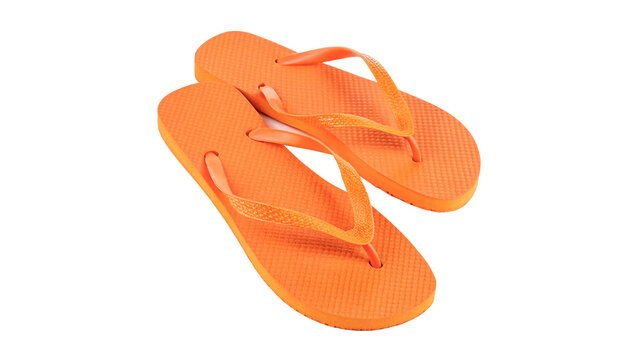 Pair of bright orange rubber beach flip flops slippers summer footwear isolated