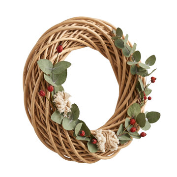 Woven rattan Christmas wreath with botanical greenery and natural fiber details, modern rustic handmade holiday decoration for commercial catalogs on transparent background
