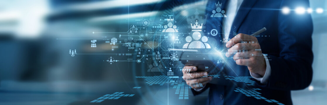 Change management consultant working on tablet analyzing corporate leadership framework development strategies, tracking cross-functional team execution, and planning future enterprise milestones.