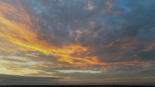 Golden sunrise over Mae rim district, Chiang Mai, Thailand spreads warm light across foggy suburbs.