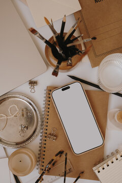 Flat Lay Composition Of Creative Desk Essentials With Blank Mobile Screen Mockup And Kraft Notebooks