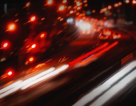 Abstract long exposure light trails of traffic on a city street at night