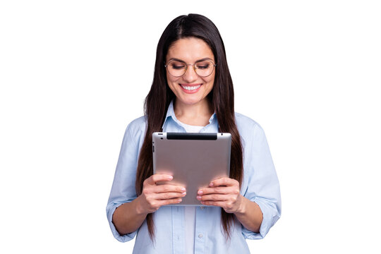 Photo of funny charming young lady dressed blue shirt glasses looking modern gadget isolated grey color background