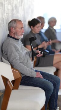 People of different ages sitting in clinic queue while waiting for doctor appointment . High quality 4k footage