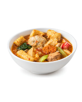 Spicy Indonesian seblak soup with meatballs tofu vegetables and crackers isolated on white background